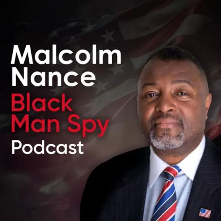 text reads "Malcolm Nance Black Man Spy Podcast"  Malcolm is pictured in a suit and a red white and blue tie with an American Flag lapel pin