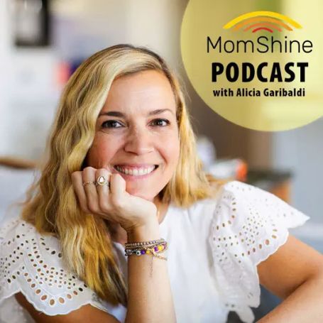text reads "MomShine Podcast with Alicia Garibaldi".  Alicia is smiling with her chin rested on her hand, the background blurred out.